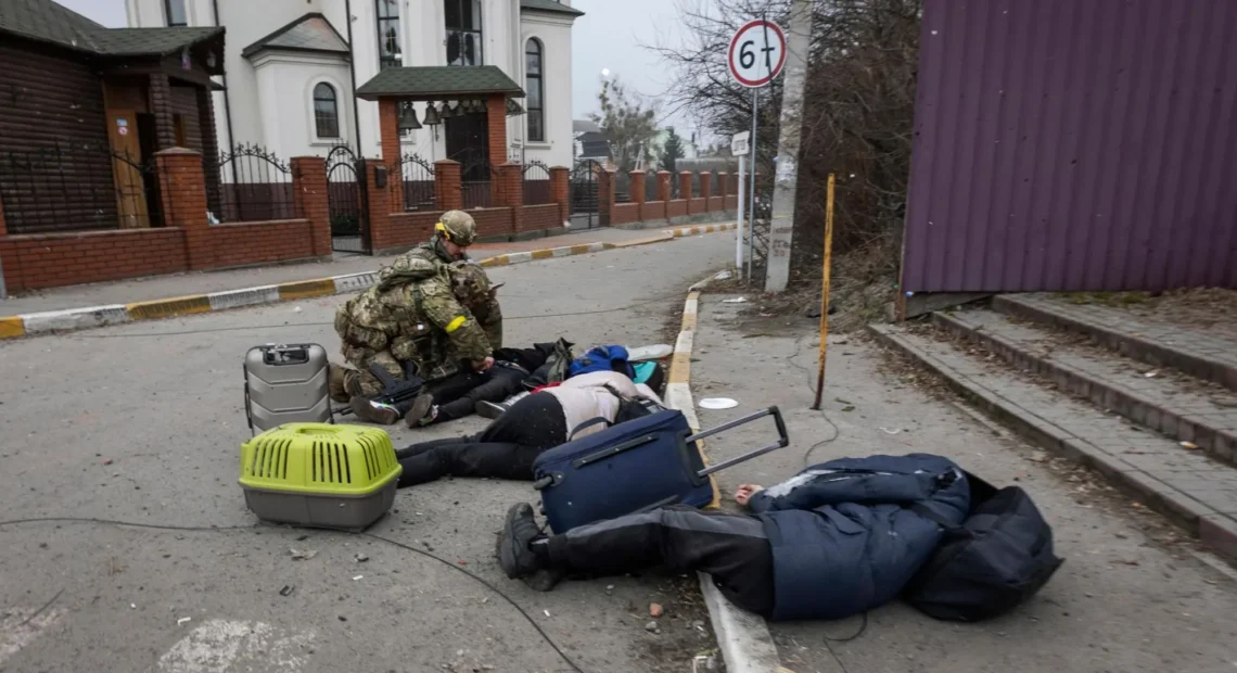 Ukrainian servicemen try to help people wounded, in the town of Irpin, Ukraine, Sunday, March 6, 2022. With the Kremlin’s rhetoric growing fiercer and a reprieve from fighting dissolving, Russian troops continued to shell encircled cities and the number of Ukrainians forced from their country grew to over 1.4 million. (AP Photo/Andriy Dubchak)