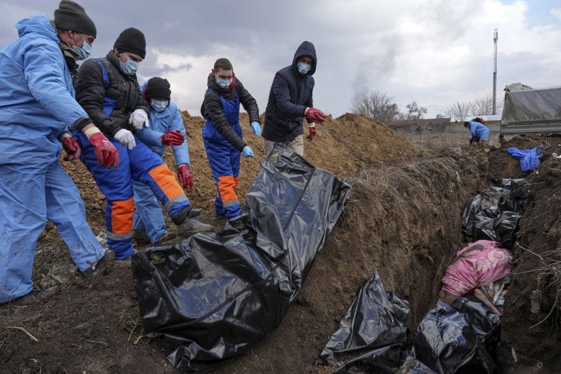 Dead bodies are placed into a mass grave on the outskirts of Mariupol, Ukraine, Wednesday, March 9, 2022, as people cannot bury their dead because of the heavy shelling by Russian forces.
EVGENIY MALOLETKA/AP PHOTO